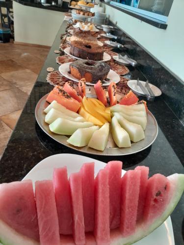 a row of plates of fruit on a table at Pousada Vila do Mar in São Luís