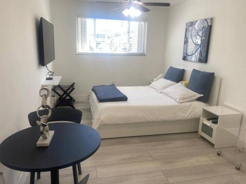 a small bedroom with a bed and a table at Excellent location Miami Brickell Studio in Miami