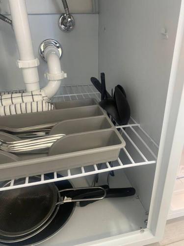 a kitchen with dishes and utensils on a shelf at Excellent location Miami Brickell Studio in Miami