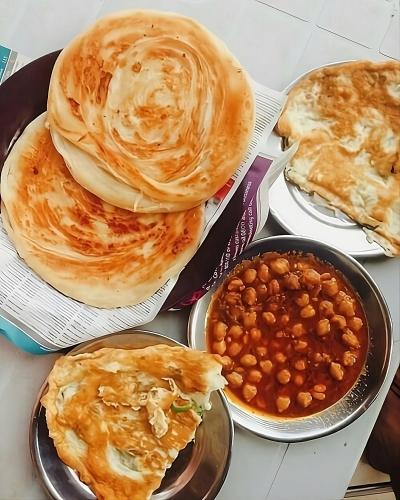 a group of plates of food with pancakes and beans at Shaiz Apartments Bhurban, Murree in Murree