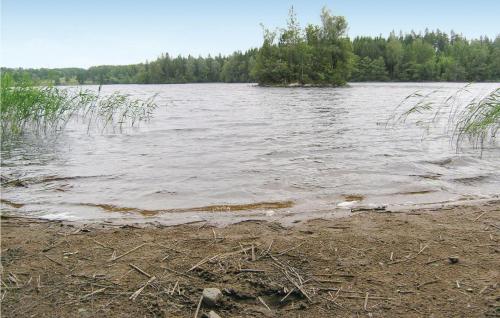 a large body of water with trees in the background at Two-Bedroom Holiday Home In Unnaryd in Unnaryd