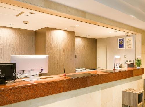 a large mirror on the wall of a hospital lobby at Sun Royal Kawasaki in Kawasaki