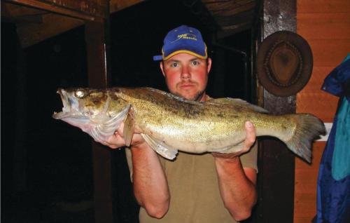 a man holding a fish in his hands at Nice Home In Gislaved With Sauna in Våthult