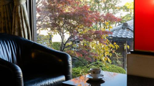 a coffee cup sitting on a table in front of a window at Nara Park Hotel in Nara
