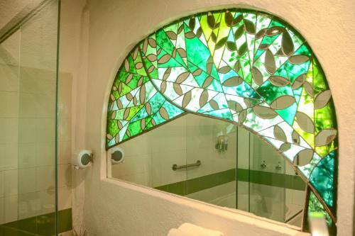 a bathroom with a stained glass window in a shower at Mesón De Leyendas Breakfast & Downtown in Valle de Bravo