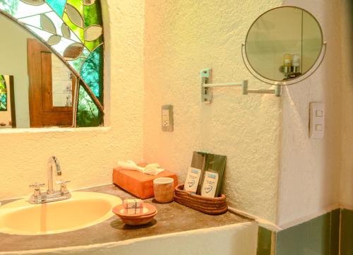 a bathroom with a sink and a mirror at Mesón De Leyendas Breakfast & Downtown in Valle de Bravo