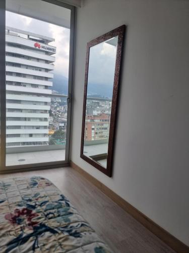 a mirror in a room with a view of a city at Suite Martina 2 Personas Quito in Quito