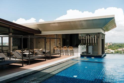 a swimming pool on the roof of a building at Zuri Hotel in Iloilo City