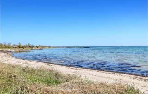 a sandy beach with the ocean in the background at 3 Bedroom Gorgeous Home In Löttorp in Löttorp