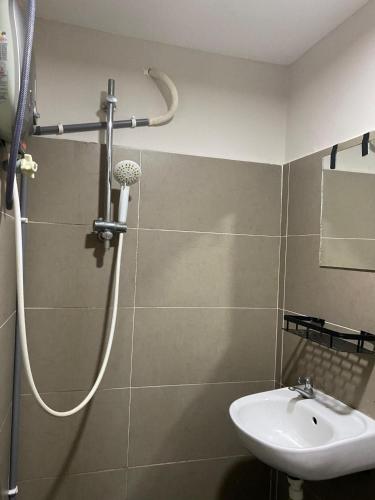 a bathroom with a shower and a sink at Aayu Muntri - 4 mins to Chulia St George Town in George Town