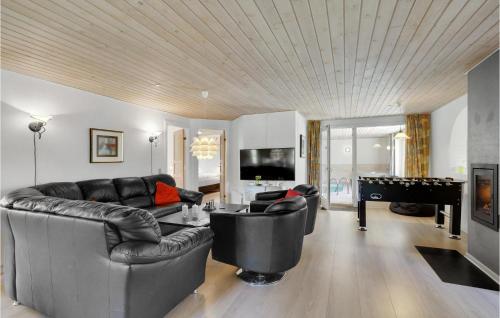 a living room with a couch and a pool table at Awesome Home In Løgstør With Sauna in Trend