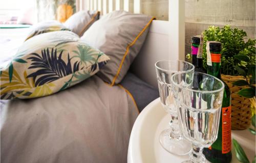 a table with two wine glasses and a couch at Nice Home In Gniewino With Kitchen in Gniewino