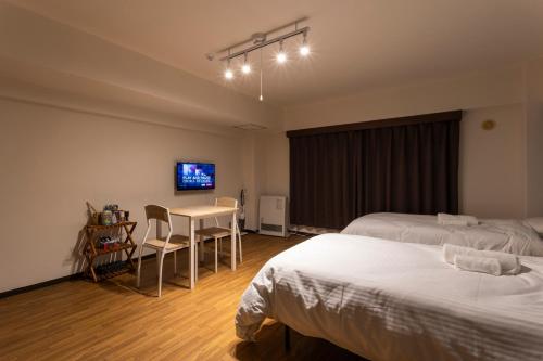 Una cama o camas en una habitación de Lake Toya BLDG 2F-3F レイクトーヤビルディング 2F-3F