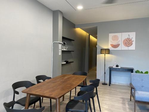 a dining room with a wooden table and chairs at Aayu Muntri - 4 mins to Chulia St George Town in George Town