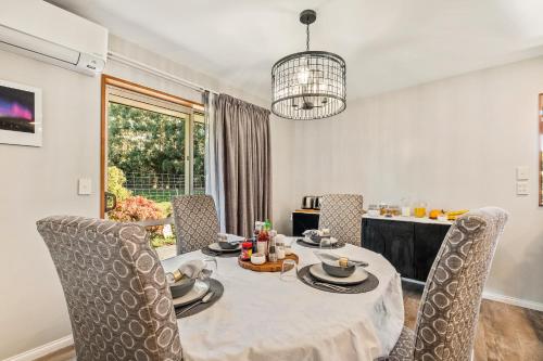 a dining room with a table and chairs at Birdsong Alley Bed and Breakfast in Hanmer Springs