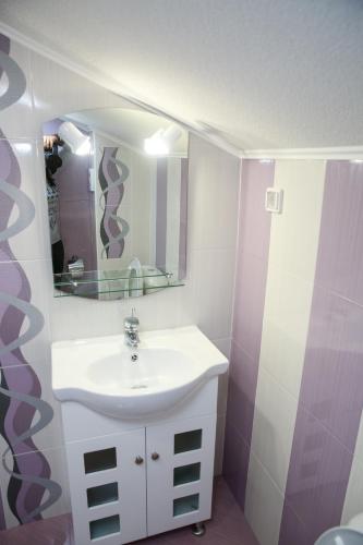a bathroom with a sink and a mirror at Станчевата Къща in Zlatograd