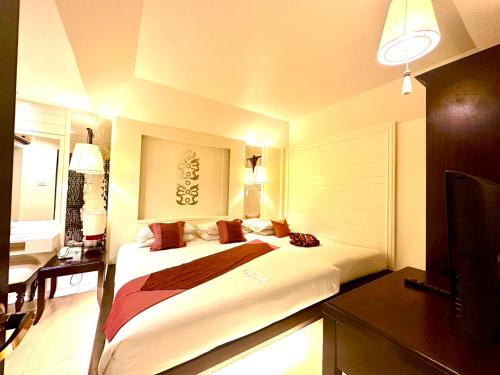 Postel nebo postele na pokoji v ubytování Chiangmai Gate Hotel