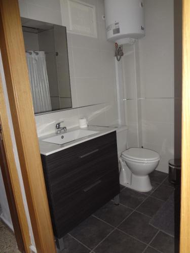 a bathroom with a sink and a toilet at Hotel Carlos I in Torremolinos