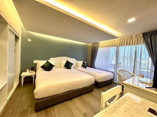 Postel nebo postele na pokoji v ubytování Chiangmai Gate Hotel