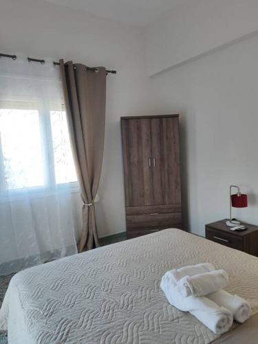 a bedroom with a bed with two towels on it at Odysseus family house in Stefaniá