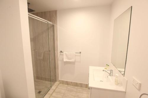 a bathroom with a shower and a sink at The Palms Apartments in Adelaide