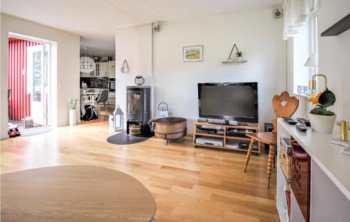 a living room with a large flat screen tv at Awesome Home In Hörby With Kitchen in Hörby