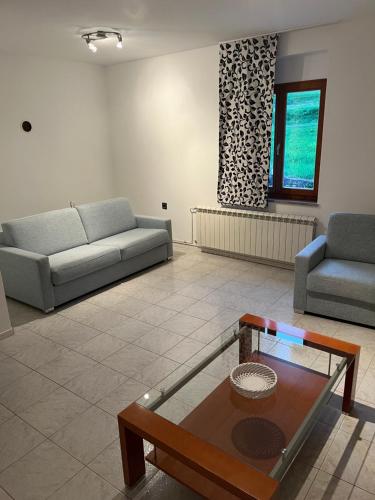 a living room with a couch and a coffee table at Apartmaji Klabjan - Kaki in Osp