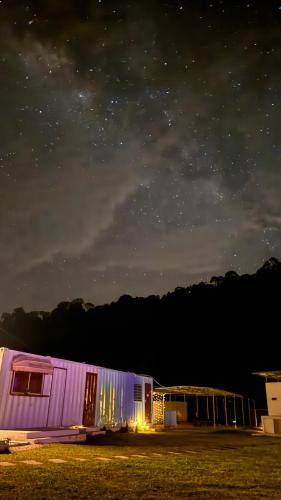 a purple building under a starry sky at night at The Starry Dome Couple Room in Cameron Highlands