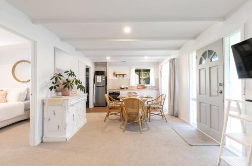 a kitchen and living room with a table and chairs at The Cottage- Pet friendly, Golf, Ocean and River! in Ocean Grove