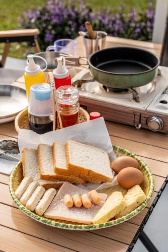 a plate of toast and bread on a table at The Starry Dome Couple Room in Cameron Highlands