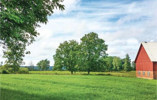 an old red barn in a field with trees at Nice Home In Gislaved With Sauna in Gislaved