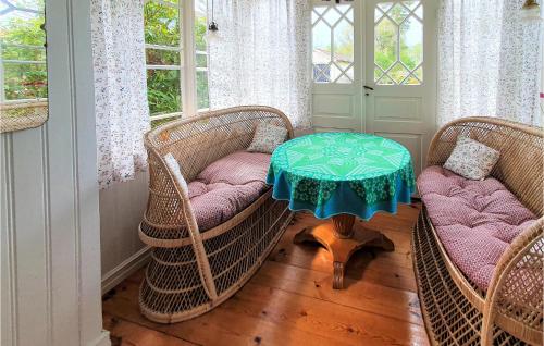 a room with three wicker chairs and a table with a table at Bolmen in Bolmen