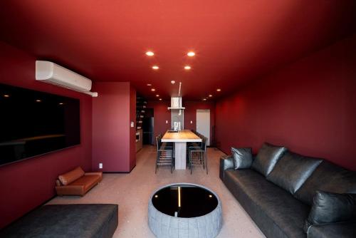 a living room with a couch and a table at THE SECOND Chousei Beach Village 3階建てペット不可 in Jōnouchi