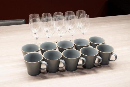 a group of wine glasses and cups on a table at THE SECOND Chousei Beach Village 3階建てペット不可 in Jōnouchi