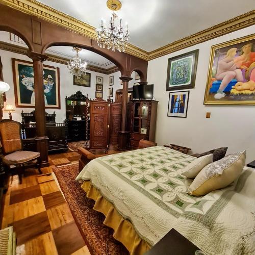 a bedroom with a large bed in a room at Hotel Boutique Casa San Marcos in Quito
