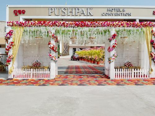an entrance to a hotel with a pavilion with flowers at PUSHPAK HOTEL & CONVENTION in Bhubaneshwar