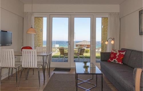 a living room with a couch and a table at Lovely Apartment In Allinge With Wifi in Allinge