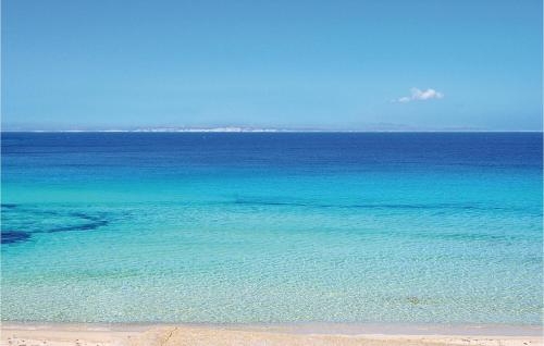 a large body of blue water with a beach at Casa Pirato in Modica