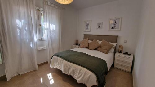 a bedroom with a large bed and a window at La Islita in Playa Blanca