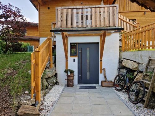 a house with a blue door and bikes parked outside at Panoramaplatzl in Goldegg