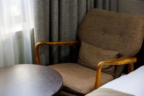 a chair sitting next to a window in a room at Jeju Robero in Jeju