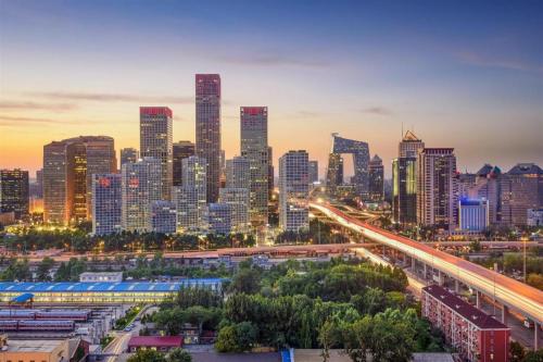 a city skyline at night with a freeway at Jianguo Garden Hotel in Beijing