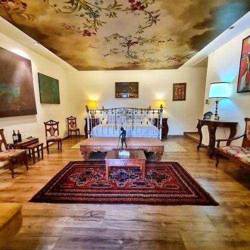 a living room with a bed and a rug at Hotel Boutique Casa San Marcos in Quito