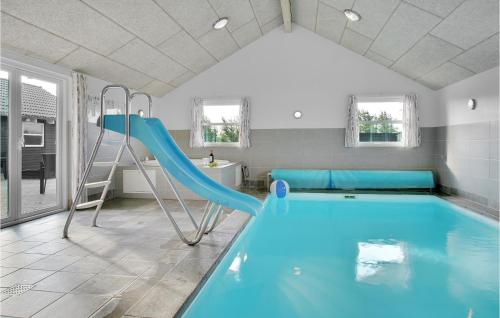 a swimming pool with a slide in a house at Lovely Home In Løkken With Wifi in Løkken