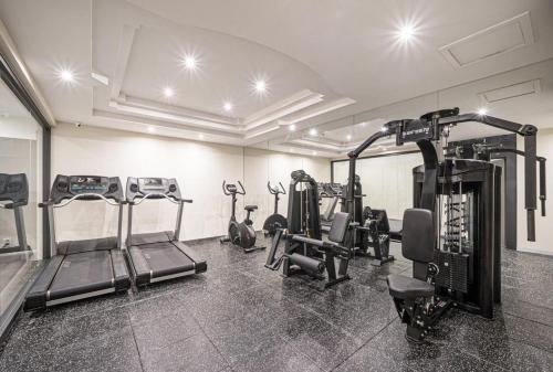 a gym with several treadms and machines in a room at Hotel TT Summit in Changwon