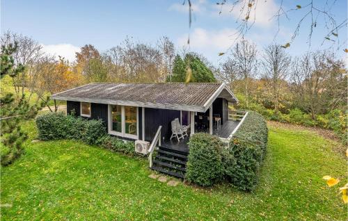 a tiny house in the middle of a yard at Beautiful Home In Rudkøbing With Wifi in Spodsbjerg