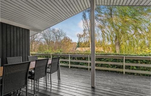 a porch with chairs and a table on a deck at Beautiful Home In Rudkøbing With Wifi in Spodsbjerg
