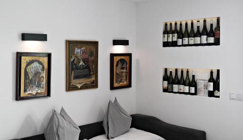 a room with bottles of wine on a wall at Lóczy Apartman in Balatonfüred