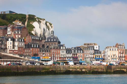 a group of buildings next to a body of water at La Ferme du Parc in Pendé