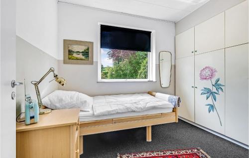 a bedroom with a bed and a desk and a window at 5 Bedroom Beautiful Home In Tranekær in Tranekær